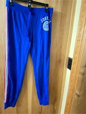 Justice Bright Blue jogger pants with red and white stripe down legs .